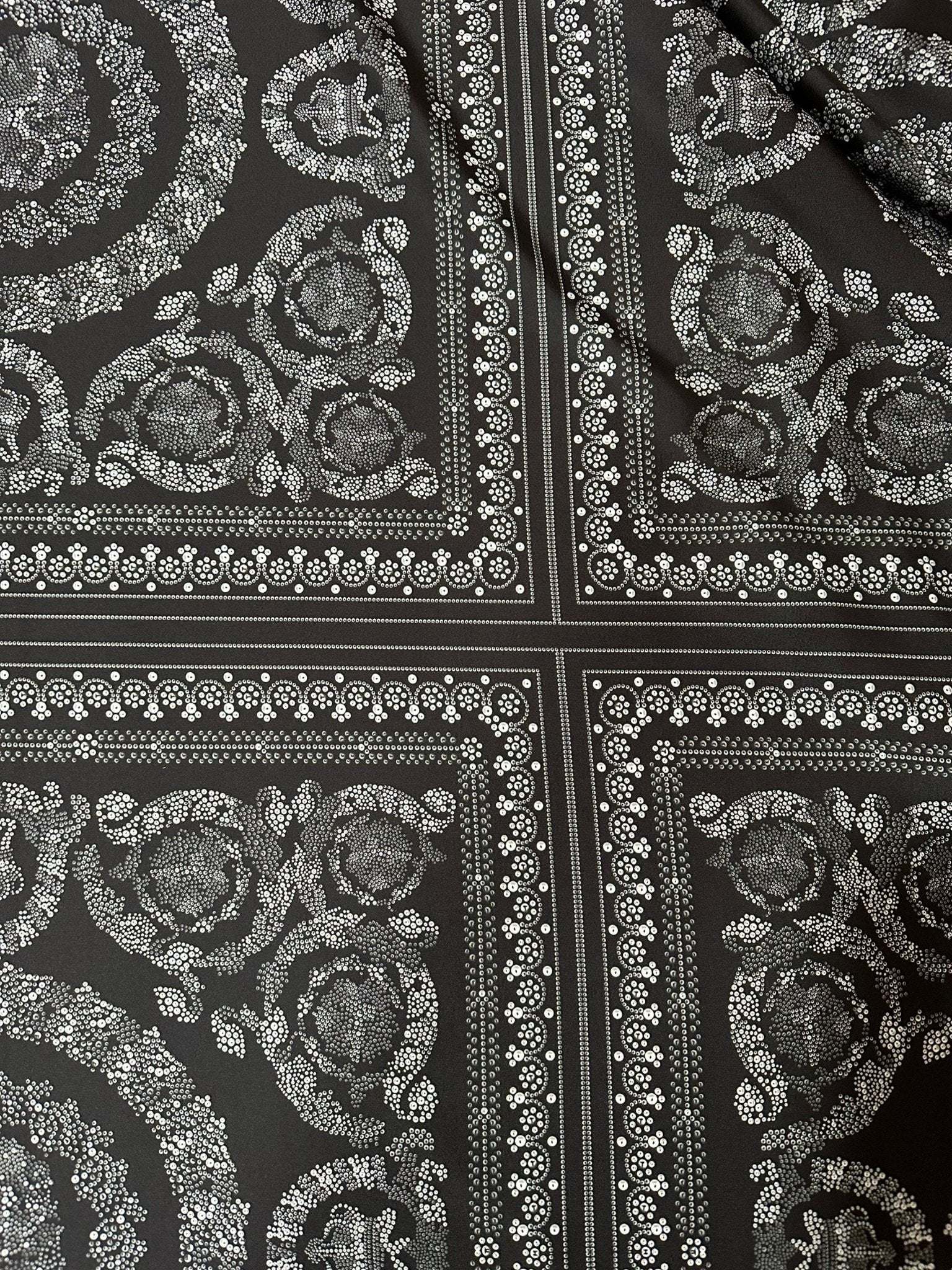 Baroque silver upholstery fabric with intricate floral and ornamental patterns on a dark background, perfect for elegant upholstery projects