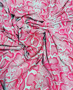 Pink and white snake skin patterned fabric with vibrant colors and 150cm width for fashion and home decor projects