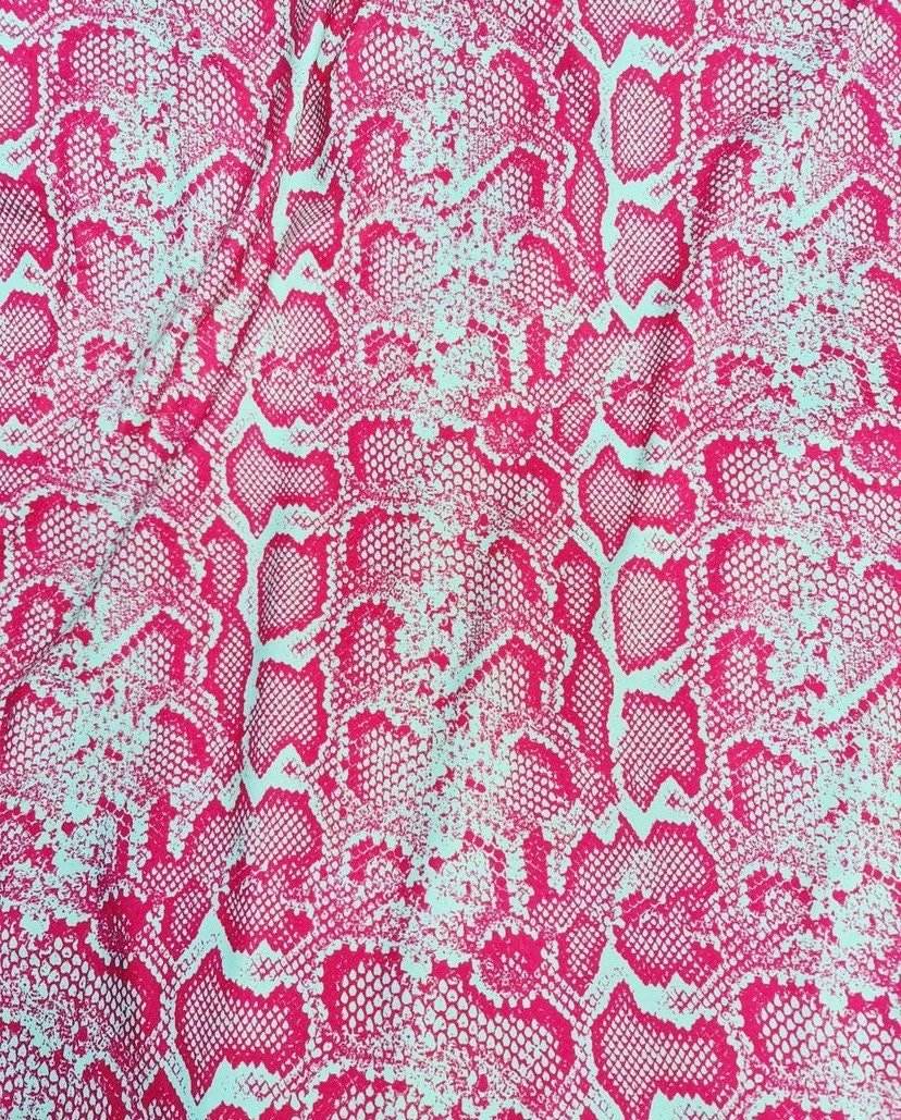 Pink and white snake skin patterned fabric with vibrant exotic animal print and 150cm width for sewing and crafting projects