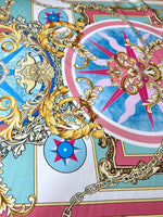 Baroque chain pattern fabric with ornate gold scrolls, compass motifs, and pastel blue and pink background