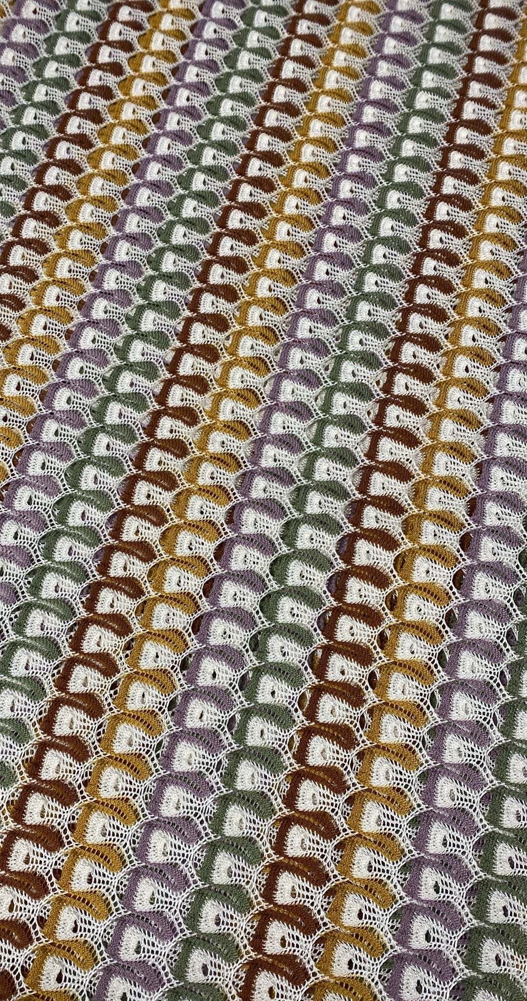 Soft color zigzag knit jersey mesh fabric with vibrant textured pattern for crafting and apparel projects