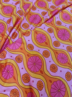 Pink geometric pattern floral fabric with vibrant orange and pink spandex design