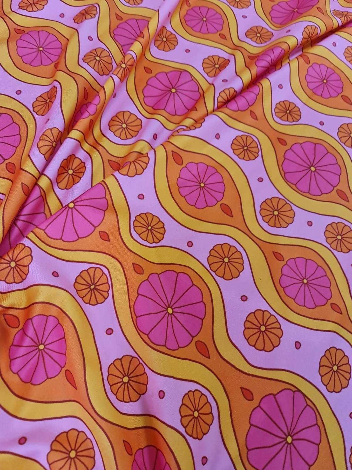 Pink geometric pattern floral fabric with vibrant orange and pink spandex design