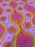 Pink geometric pattern floral fabric with vibrant pink and orange flowers and wavy yellow lines on a light pink background