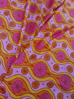 Pink geometric pattern floral spandex fabric with orange and yellow wavy lines and pink flowers, 150cm wide textile for sewing projects