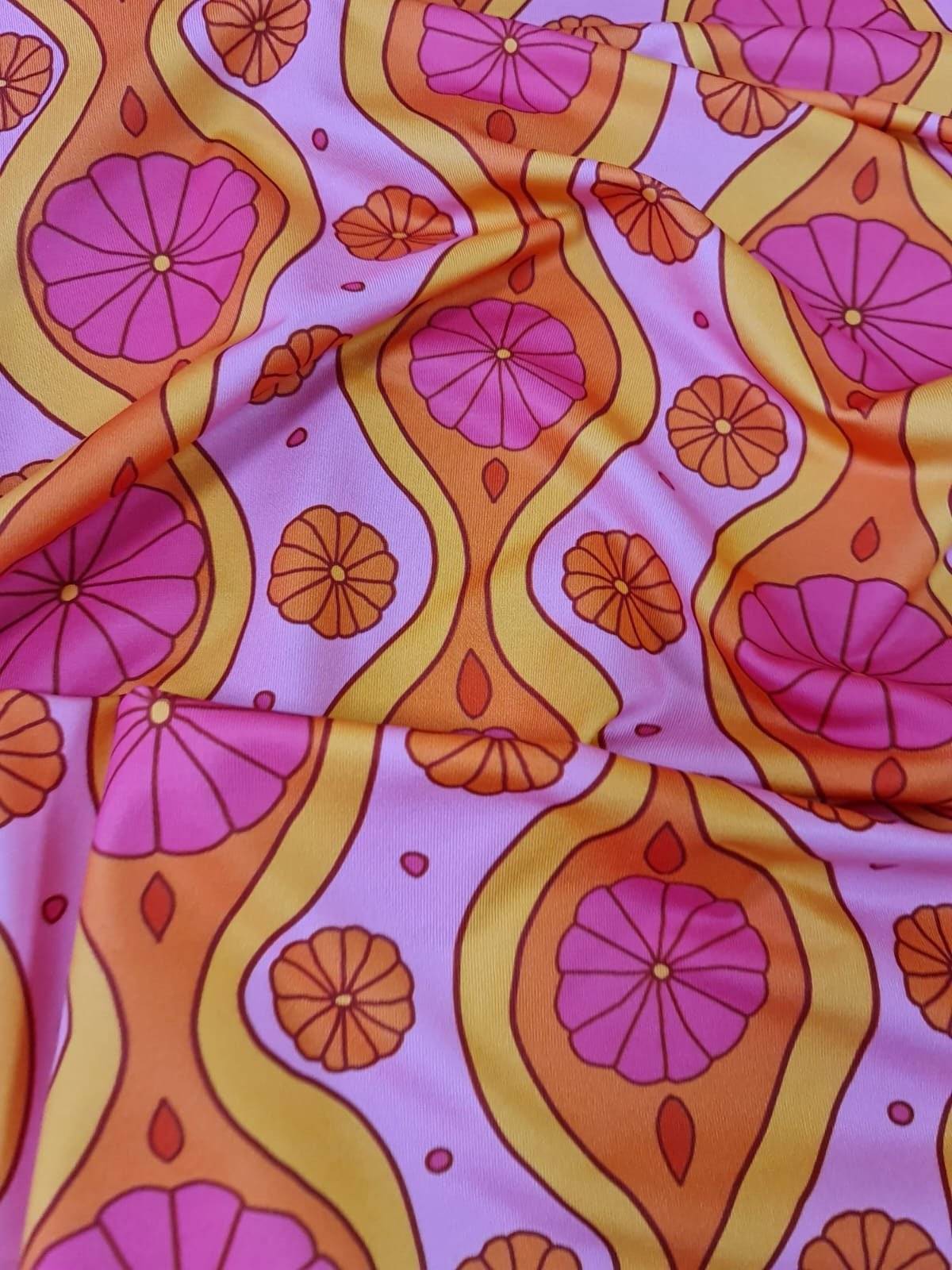 Pink geometric pattern floral spandex fabric with orange and yellow accents, 150cm wide textile for sewing projects