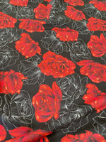 Elegant red rose patterned spandex fabric with floral design on black background, 150cm wide, stretchy and versatile for sewing projects.