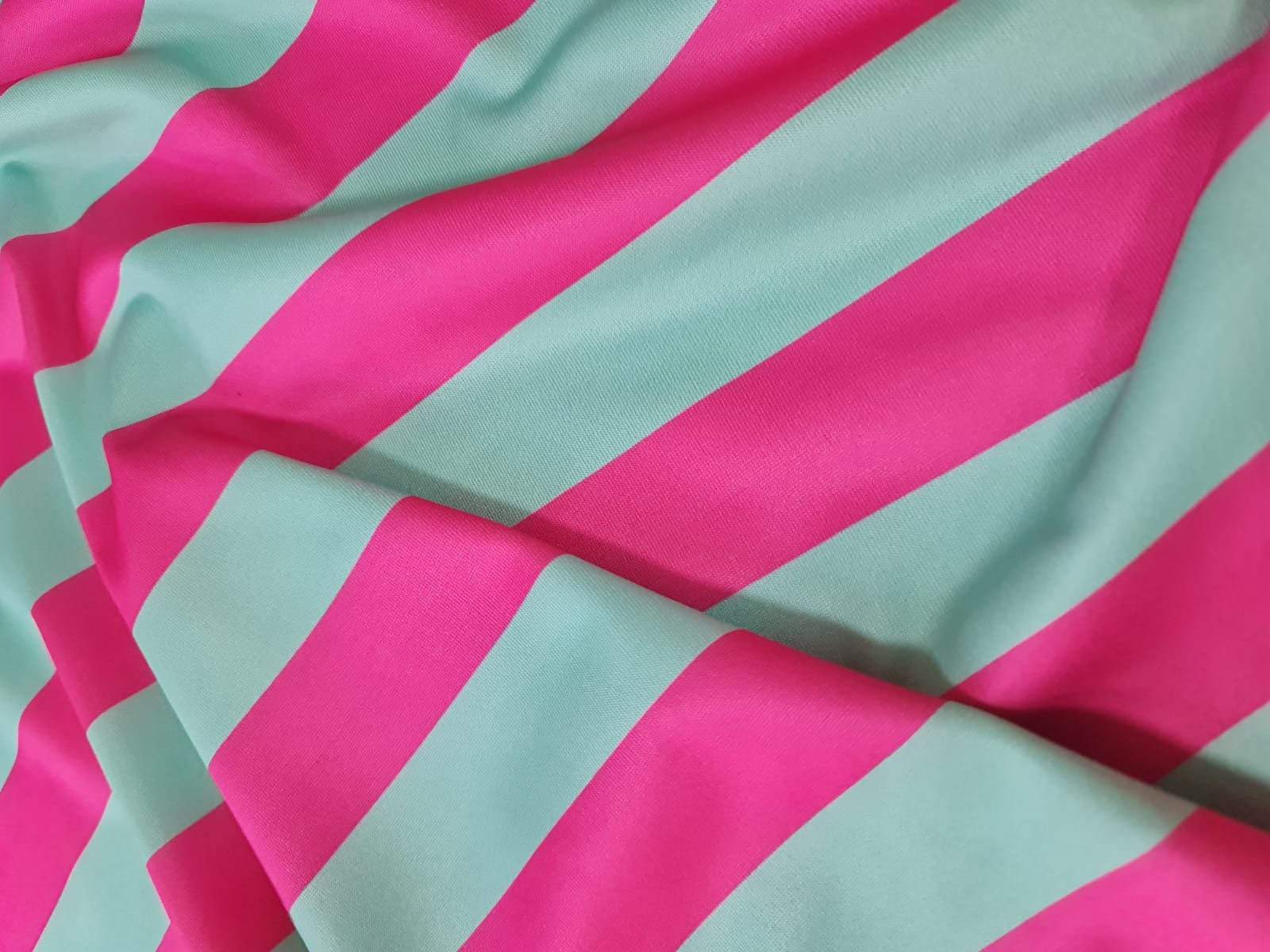 Close-up of mint green and pink striped fabric with smooth texture and 150cm width for sewing and crafting projects