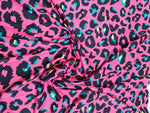 Bright sugar pink leopard print fabric with black and turquoise animal pattern, 150cm wide textile for fashion and crafts