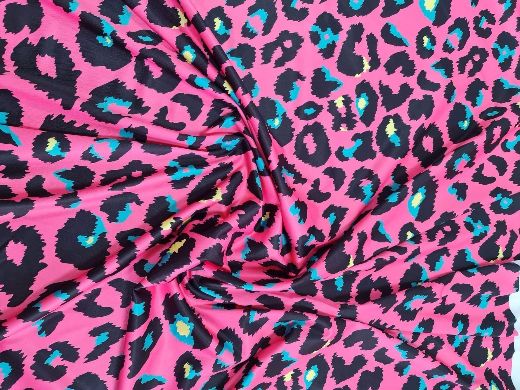Bright sugar pink leopard print fabric with black and turquoise animal pattern, 150cm wide textile for fashion and crafts
