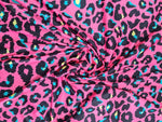 Sugar pink leopard print fabric with vibrant blue and yellow accents, 150cm wide, suitable for clothing and crafts