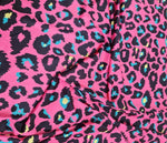 Sugar pink leopard print fabric with black spots and blue and yellow accents, 150cm wide textile for clothing and crafts.