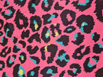 Sugar pink leopard print fabric with black and teal accents, 150cm width, bold animal pattern textile for clothing and decor projects