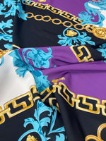 Swirl pattern crepe fabric with gold chain print in black, purple, white, and blue colors, lightweight and flowy texture