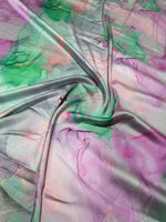 Abstract watercolor print fabric with soft green, pink, and purple tie-dye design perfect for sewing and crafts