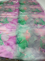 Abstract watercolor print fabric in soft pink, green, and gray tie-dye patterns for sewing and crafts