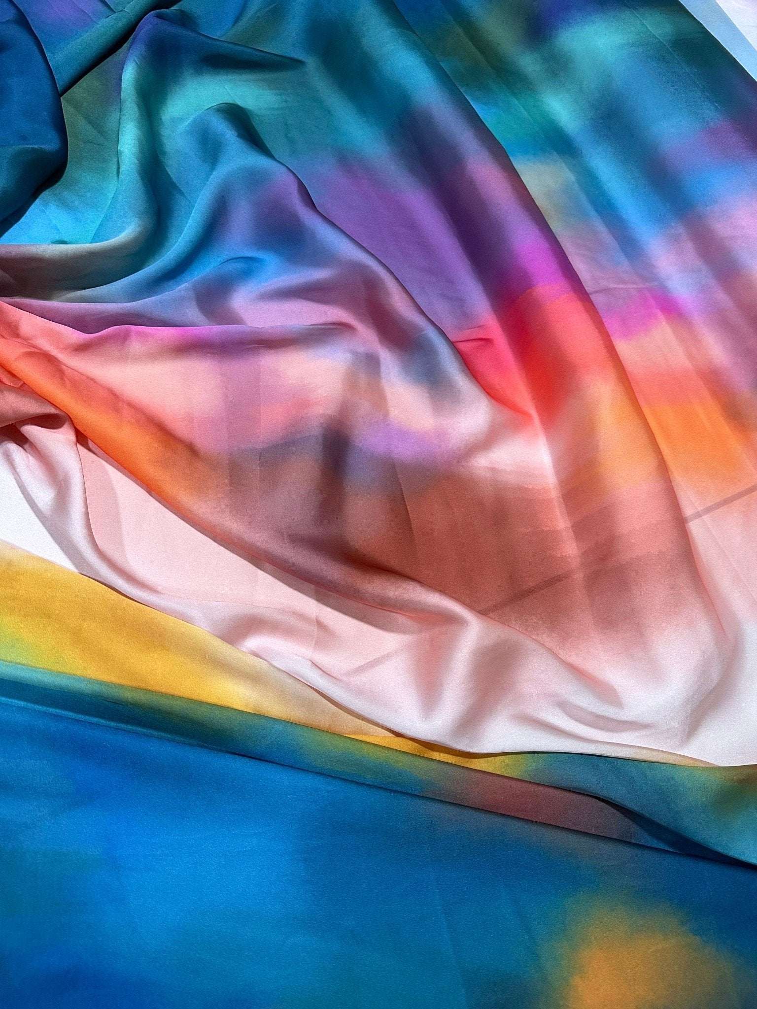 Rainbow multicolor satin fabric with smooth, vibrant gradient and luxurious finish for dresses and crafts