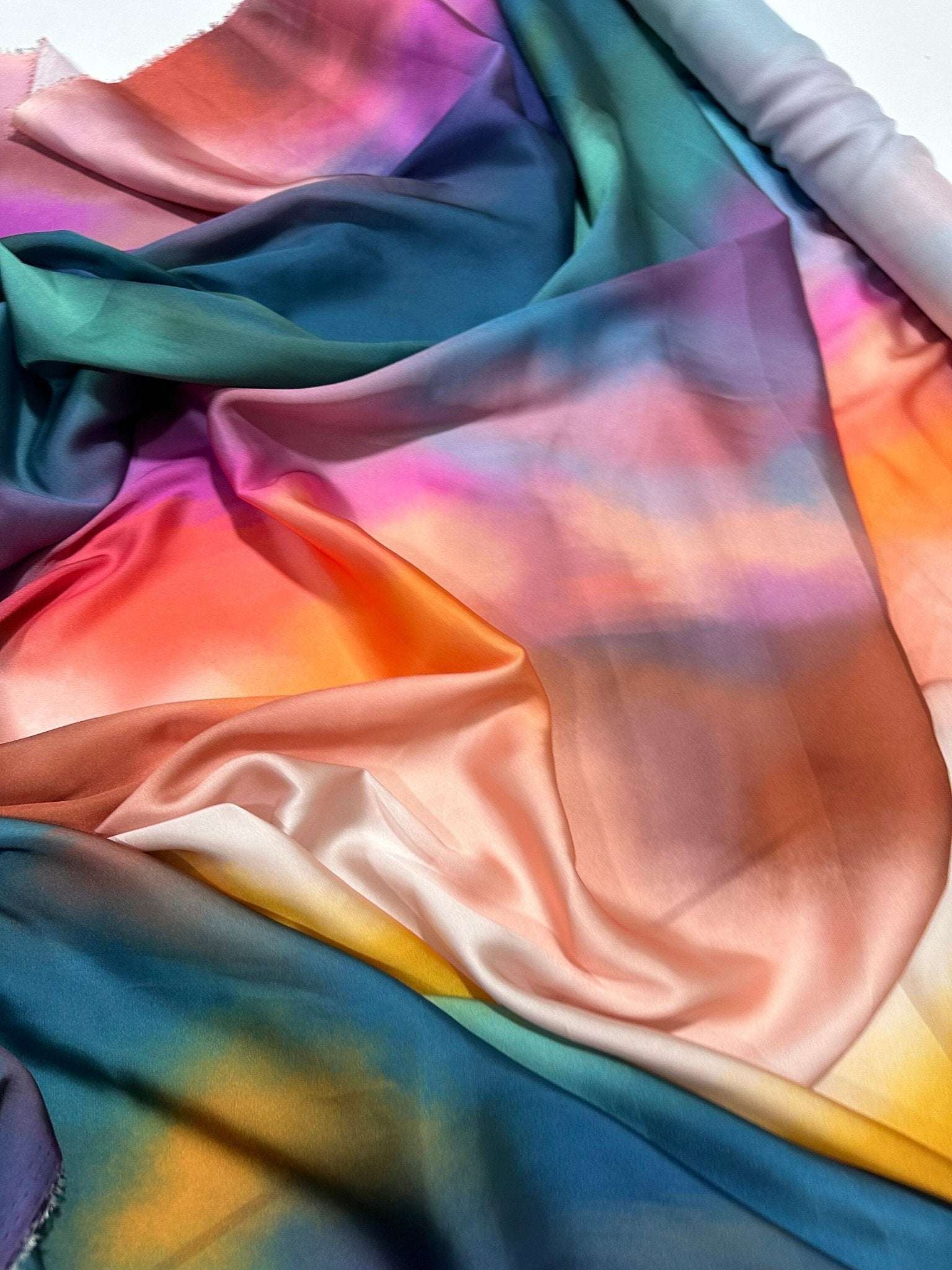 Rainbow multicolor satin fabric with smooth, vibrant, and glossy finish ideal for sewing and crafting projects