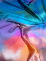 Smooth rainbow multicolor satin fabric with vibrant gradient hues for sewing and crafting projects