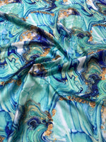 Turquoise and blue marble print fabric with swirling patterns and gold accents, 150cm width.