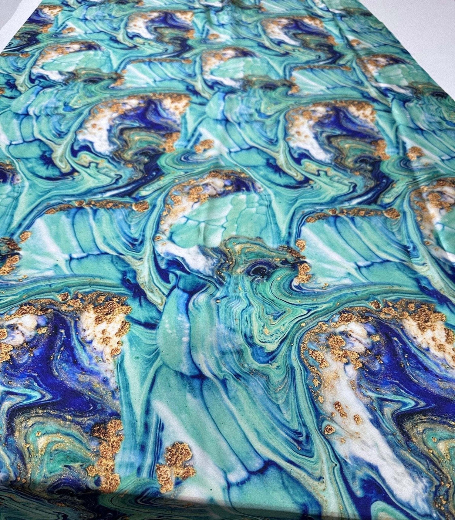 Turquoise and blue marble print fabric with gold accents and 150cm width for crafting and home decor projects