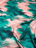 Green and pink pattern tie dye fabric with vibrant abstract design and soft texture