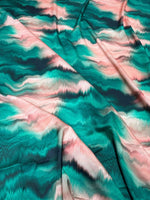 Green and pink pattern tie dye fabric with soft texture and vibrant colors for clothing and crafts
