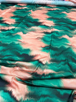 Green and pink tie dye fabric with vibrant pattern and soft texture