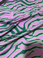 Exotic tiger pattern fabric with vibrant green and purple animal print design