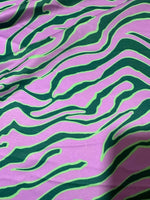 Exotic tiger pattern fabric in vibrant green and purple with 150cm width for clothing and home décor projects