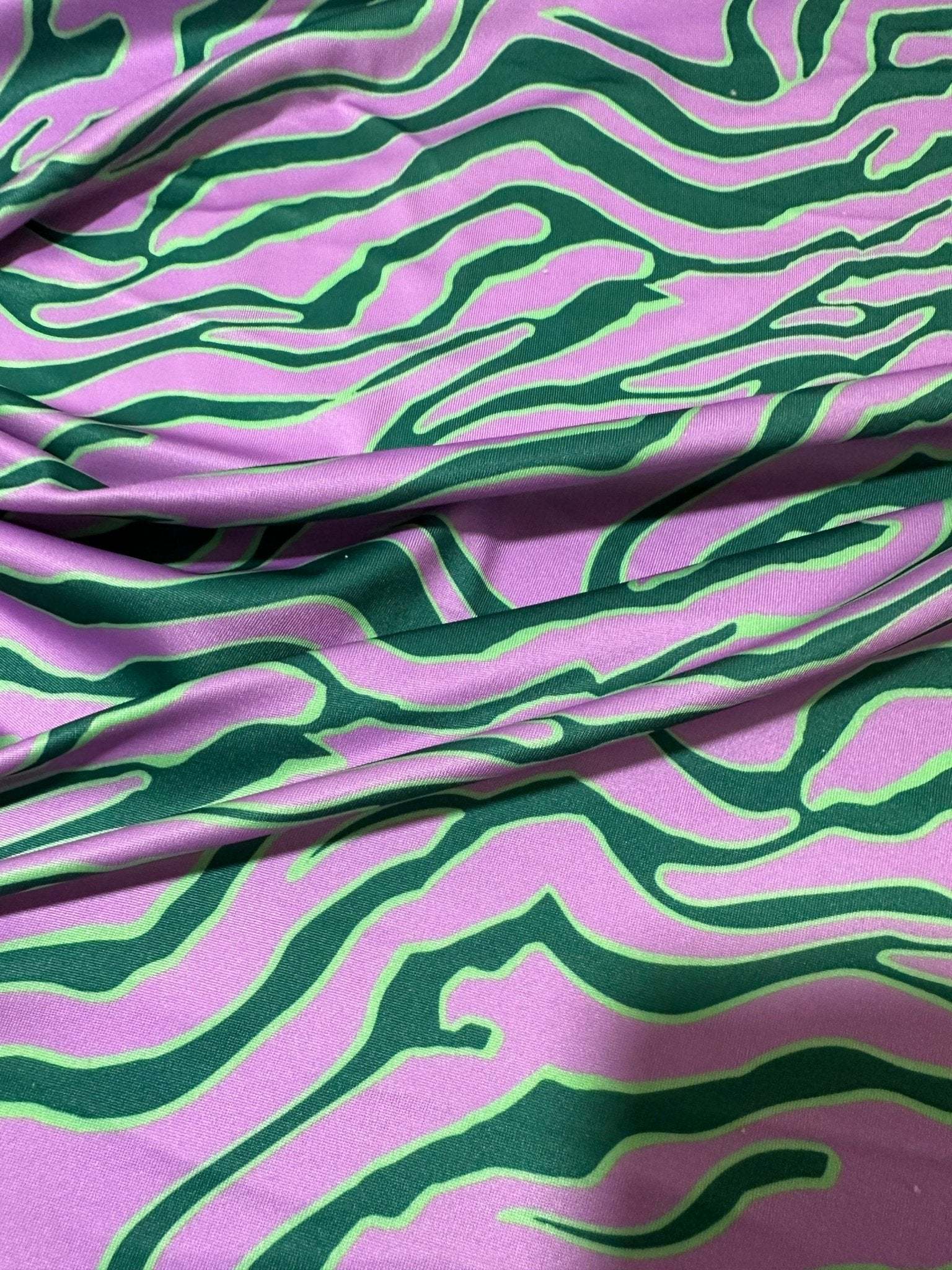 Vibrant green and purple exotic tiger pattern fabric with bold animal print design and 150cm width