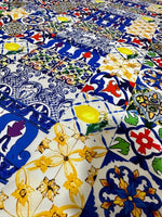 Colorful tile pattern fabric with intricate blue, yellow, red, and green designs for sewing and crafting projects