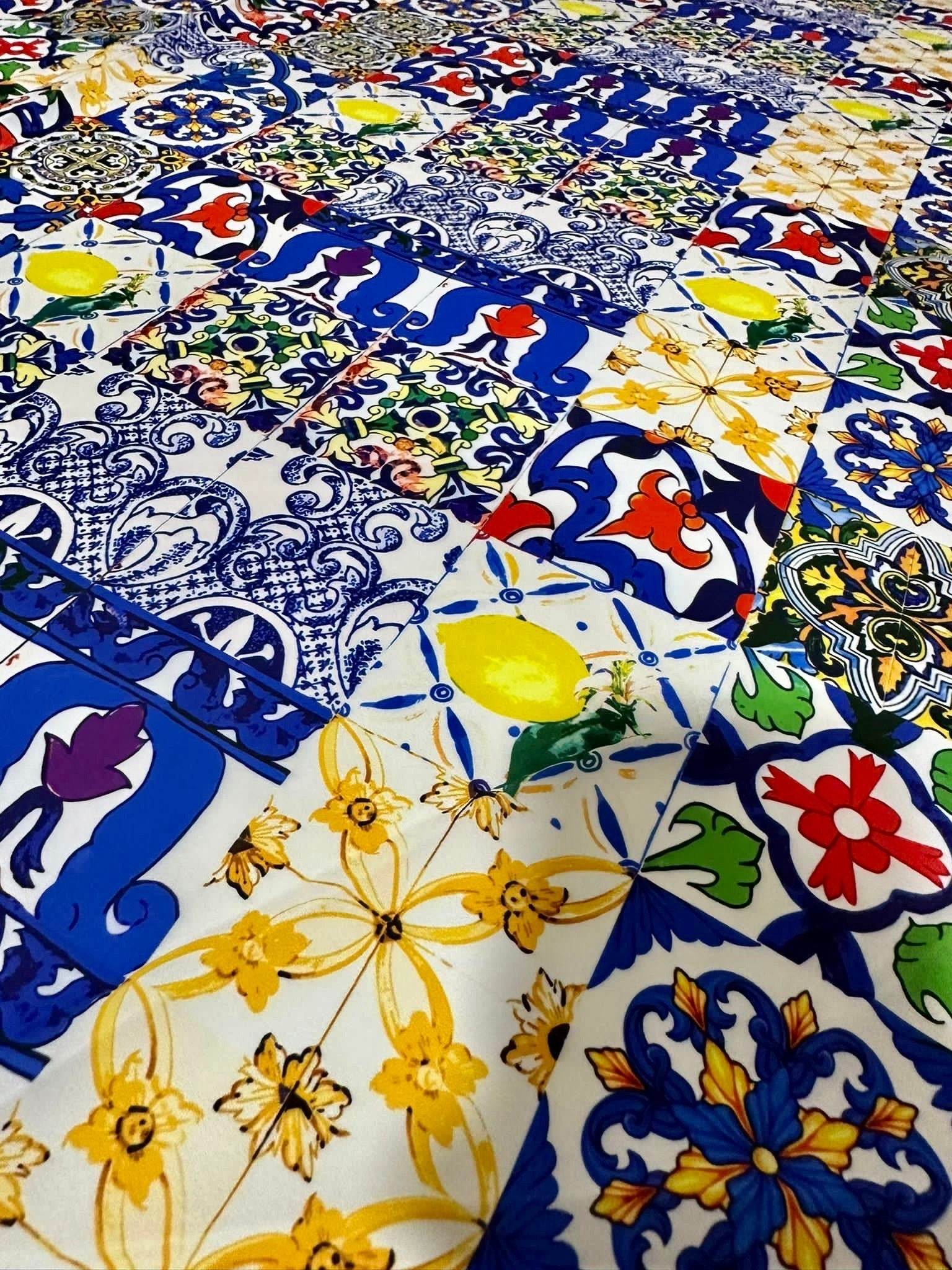Colorful tile pattern fabric with intricate blue, yellow, red, and green designs for sewing and crafting projects