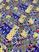 Colorful tile pattern fabric with intricate geometric and floral designs in blue, yellow, red, and green tones, suitable for sewing and crafting projects