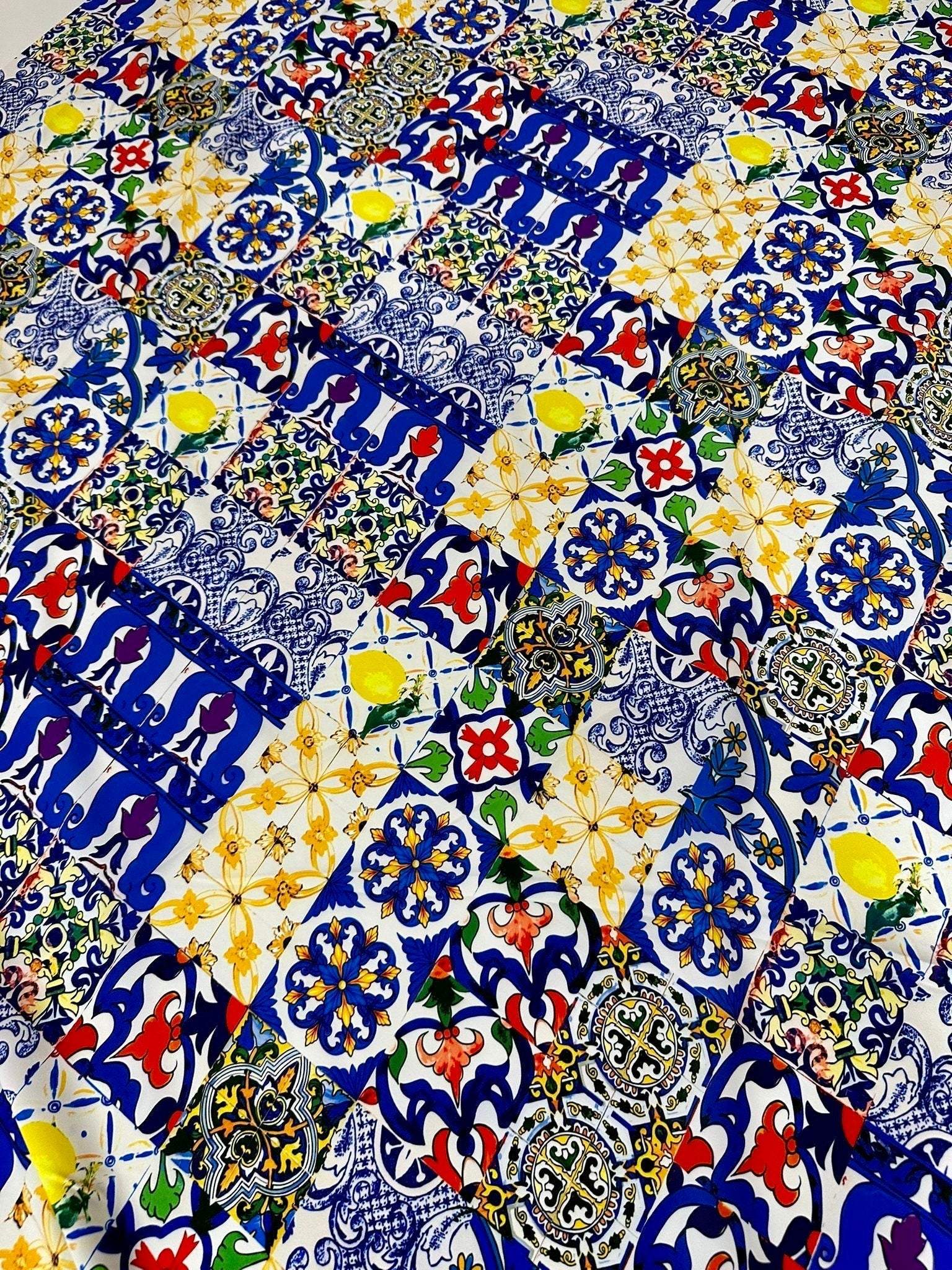 Colorful tile pattern fabric with intricate geometric and floral designs in blue, yellow, red, and green tones, suitable for sewing and crafting projects