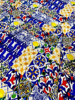colorful tile pattern fabric with blue, yellow, and red intricate designs for sewing and crafting projects