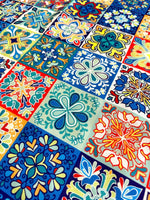 Colorful tile pattern fabric with intricate floral and geometric designs in blue, red, yellow, and green tones