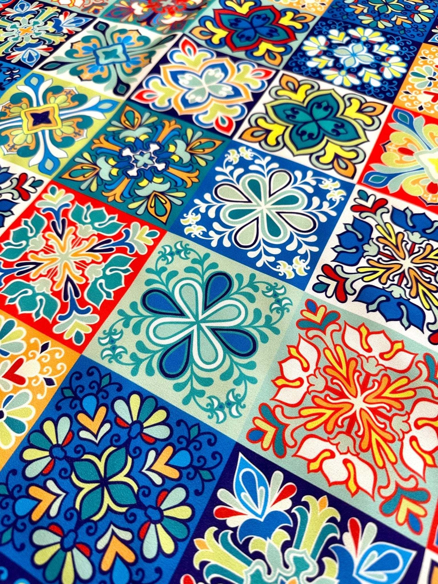 Colorful tile pattern fabric with intricate floral and geometric designs in blue, red, yellow, and green tones