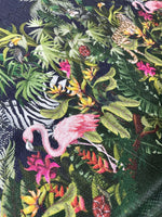 Tropical jungle print fabric with vibrant foliage, flamingos, toucans, and exotic animals on a dark background, featuring a 2-way stretch and sequin texture.