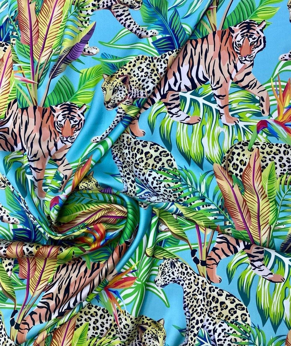 Bright tropical and leopard pattern fabric bundle with vibrant leaves and big cats on blue background