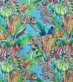 Bright tropical fabric with green leaves, colorful flowers, and leopard and tiger prints on blue background