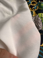 Tropical fabric with vibrant chain belt pattern in bright colors and bold design