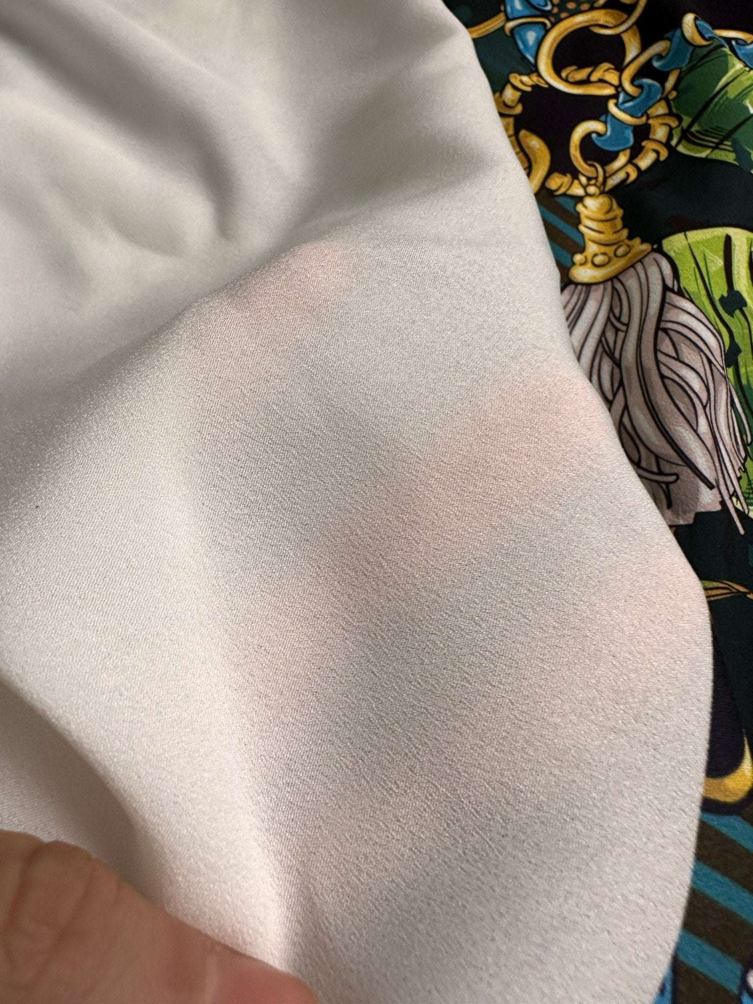 Tropical fabric with vibrant chain belt pattern in bright colors and bold design