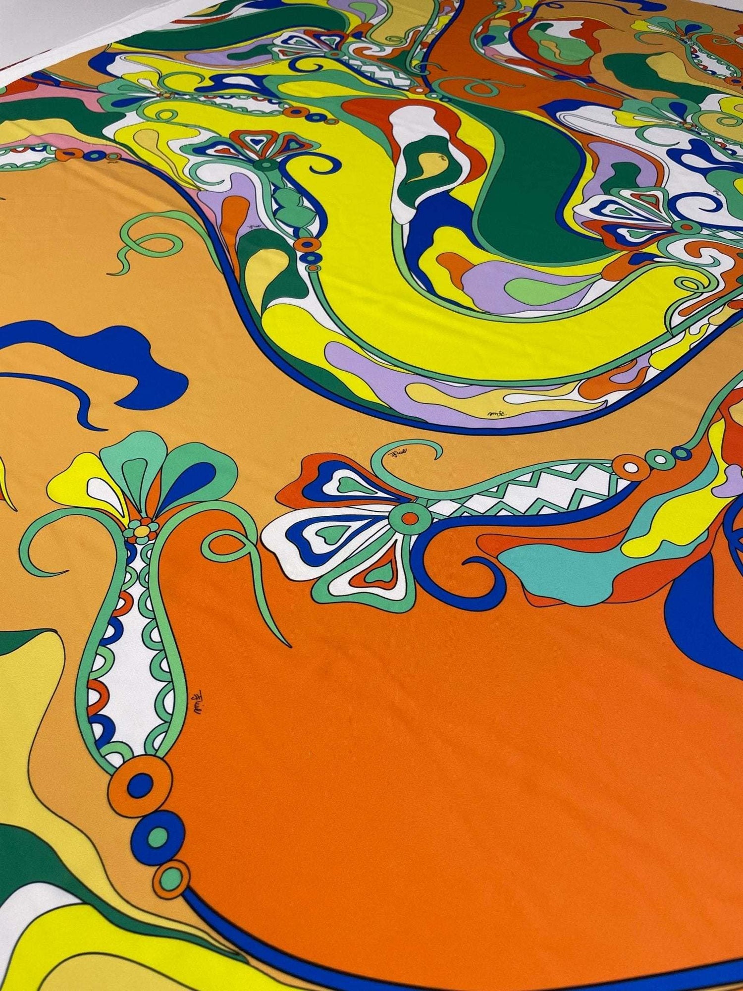 vibrant psychedelic pattern fabric with swirling colorful abstract designs on orange background