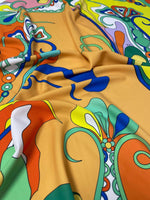 Close-up of vibrant psychedelic pattern fabric with bold colorful abstract designs and soft texture