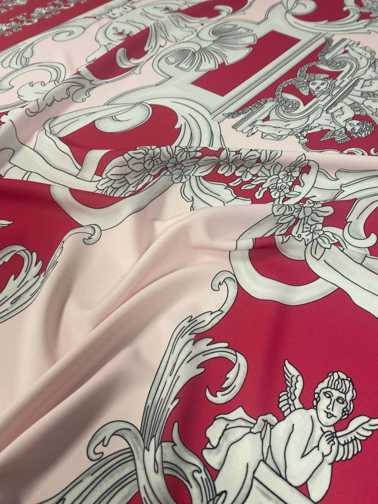 Pink vintage baroque fabric with intricate cherub pattern and ornate detailing