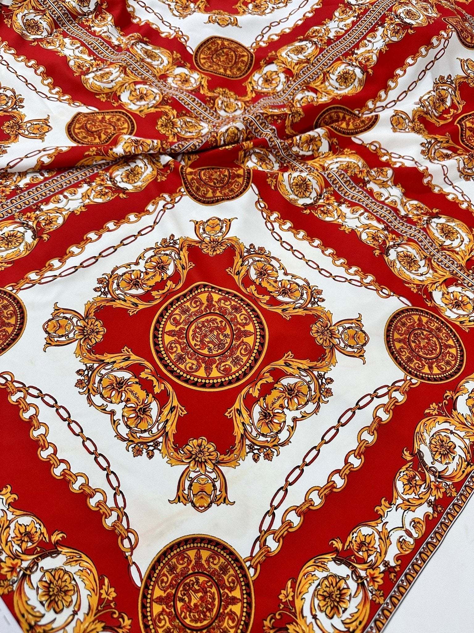red and gold vintage baroque pattern fabric with intricate ornate design and chain motifs
