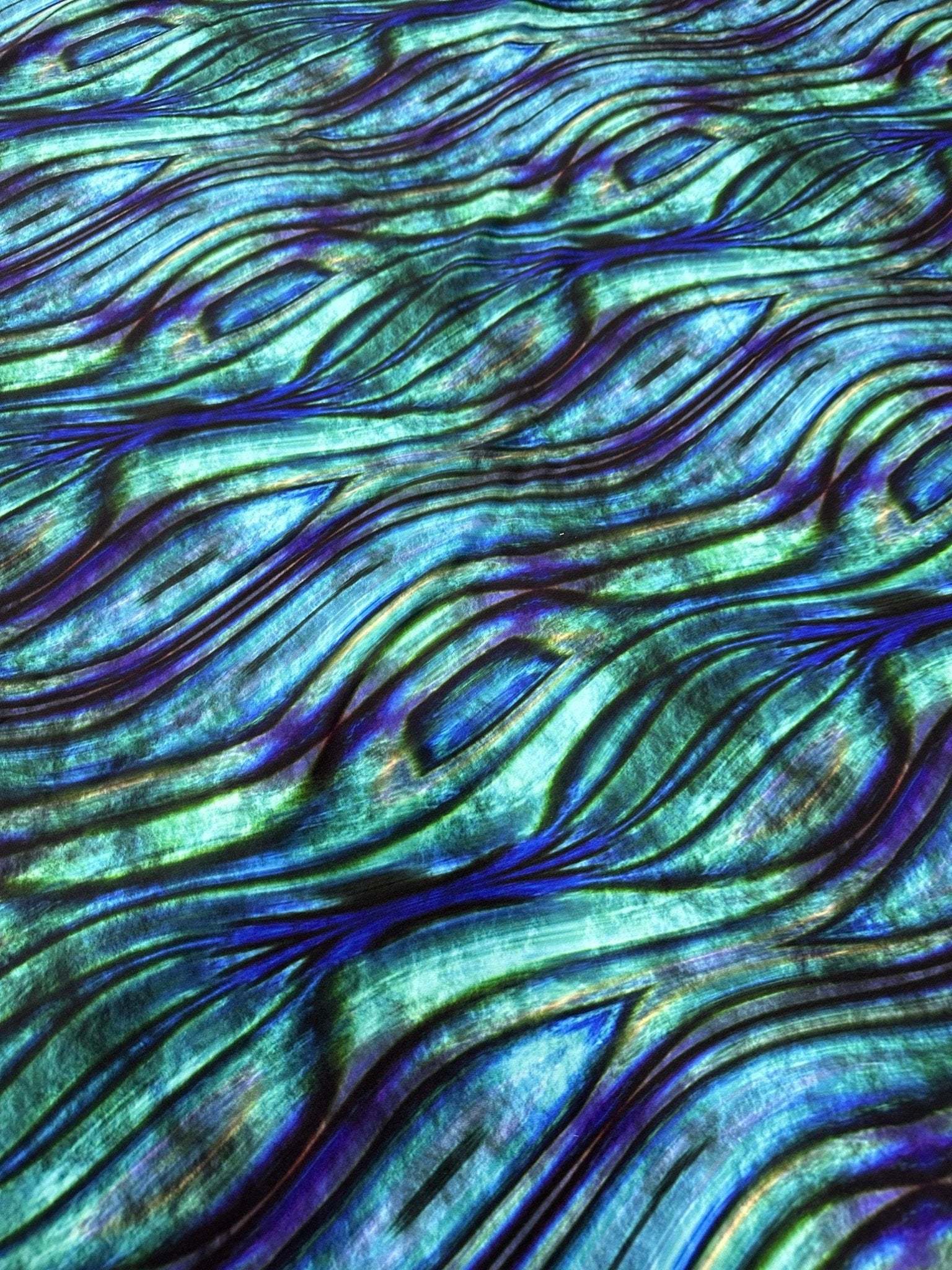 Close-up of blue and green wave pattern fabric with textured design and 150cm width for sewing and crafting projects