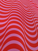 red pink striped wave pattern fabric with vibrant decorative design for sewing and quilting projects