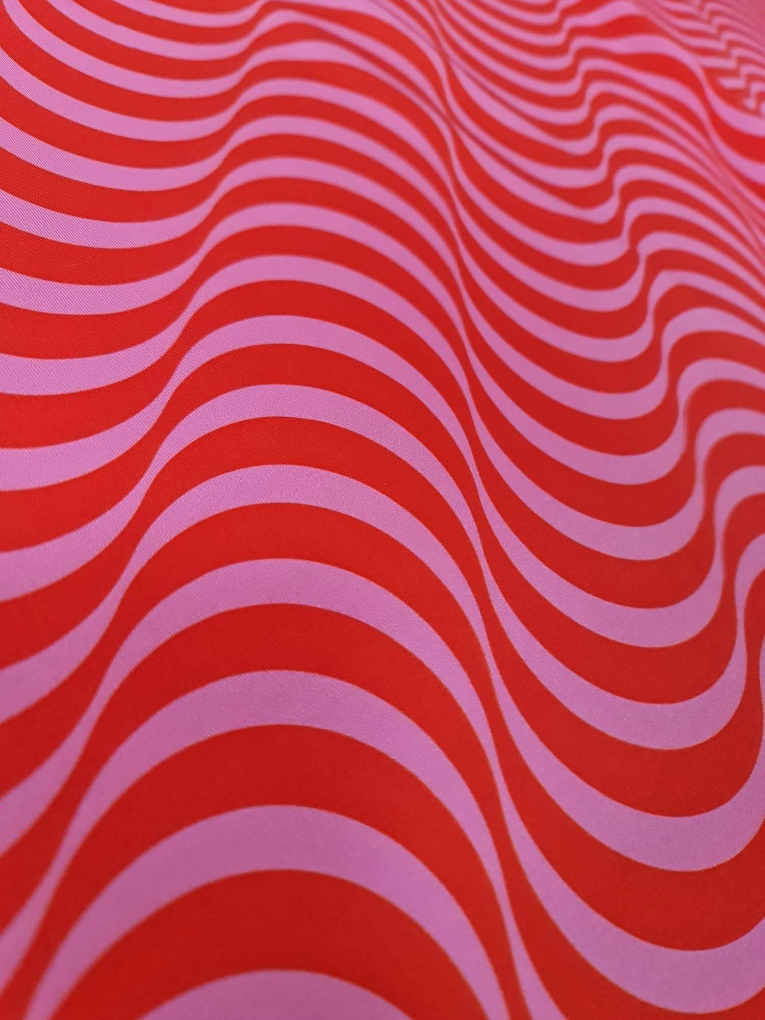 red pink striped wave pattern fabric with vibrant decorative design for sewing and quilting projects